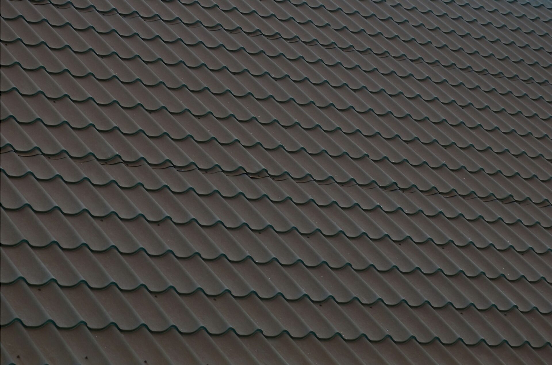 Brown metal roof tiles. Metal Roof Shingles - Roofing Construction